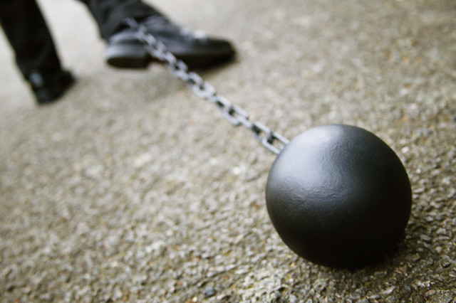 Businessman Dragging a Ball and Chain